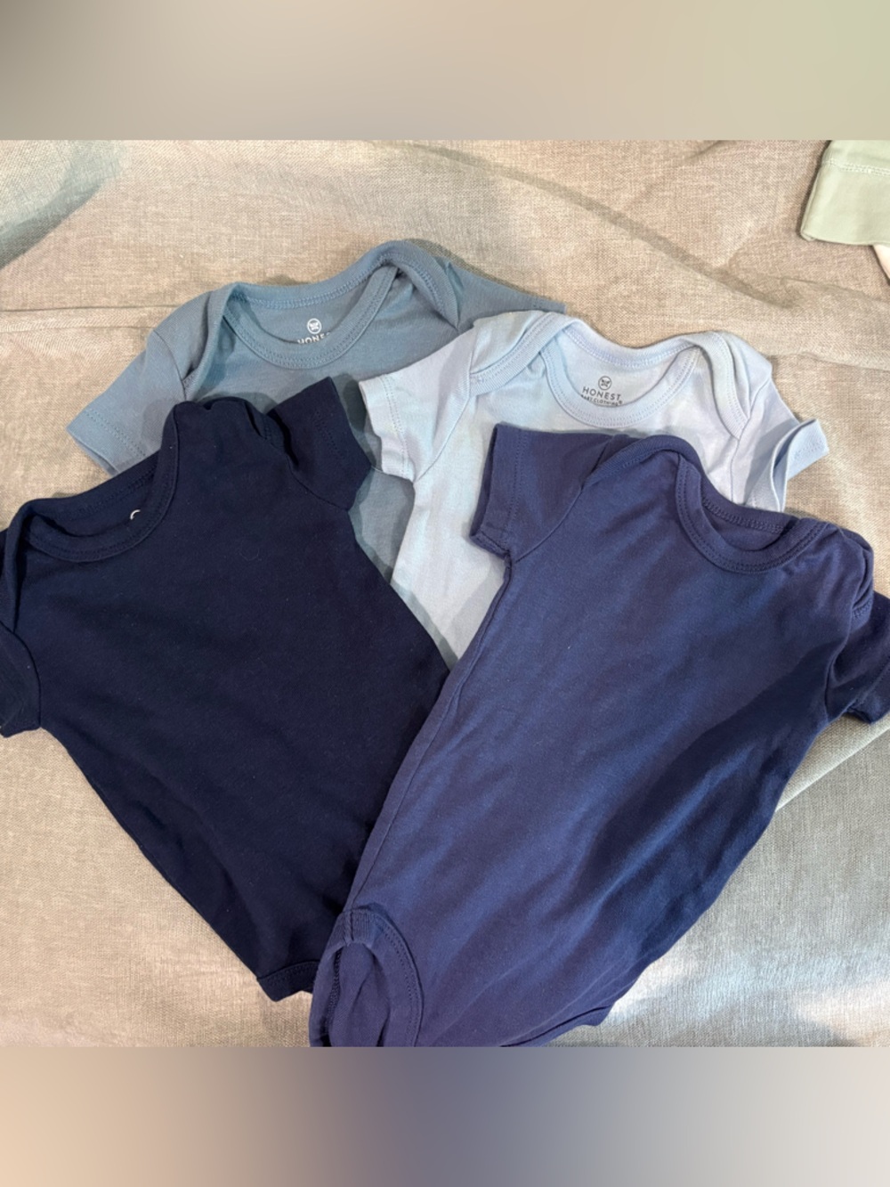 The Honest Company organic Baby One-Piece Bodysuits in Navy and Light Blue